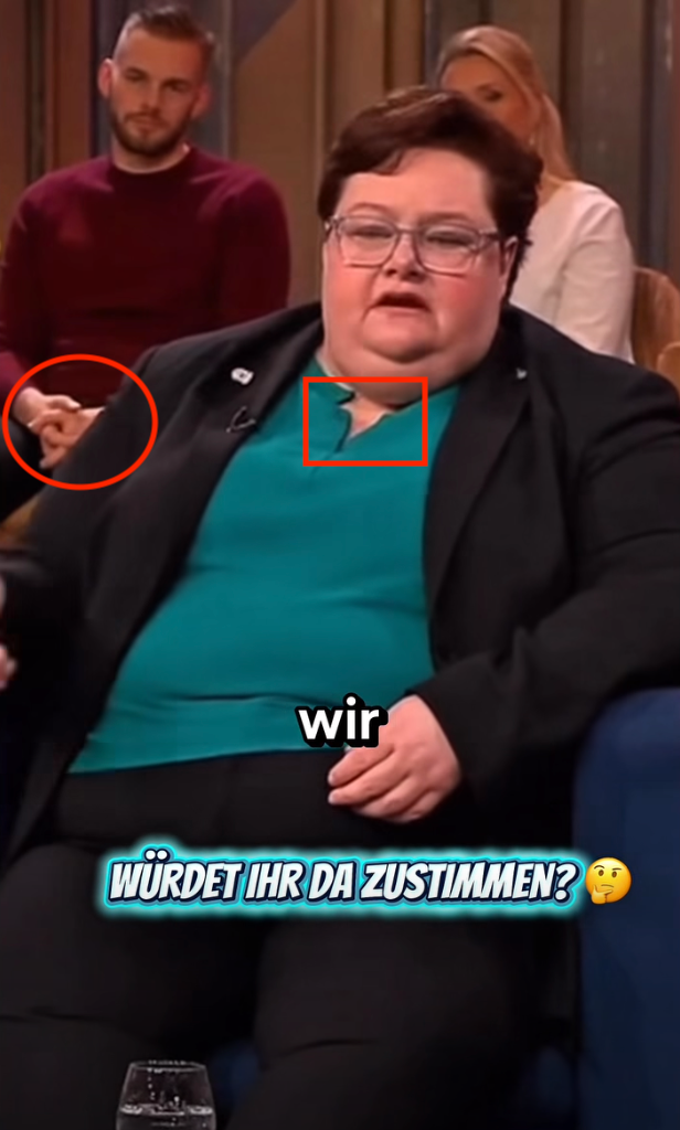 Die Kleidung der Frau ist asymmetrisch und die Hände des Zuschauers haben seltsame Proportionen